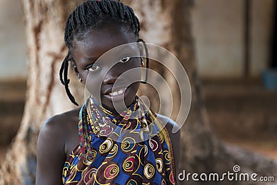 Portrait of a young African girl wearing a colorful dress in the town of Nhacra in Guinea Bissau Editorial Stock Photo