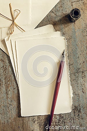 Nib Pen and Inkwell with Blank Vintage Paper and Envelopes Top View Stock Photo