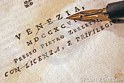 Nib (pen) over an old book Stock Photo