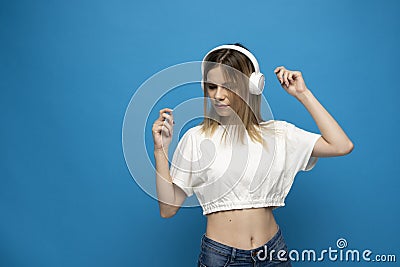 Nice attractive pretty dreamy cheerful cheery girl listening to the muisc and having fun isolated on bright blue color Stock Photo