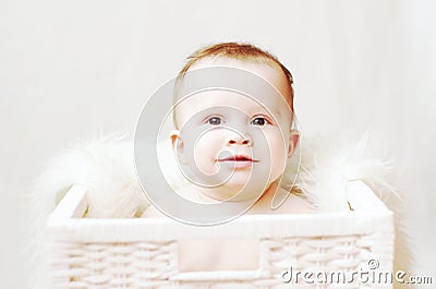 Nice baby in white basket Stock Photo