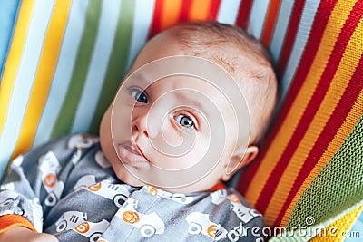 nice beautiful baby look at camera portrait on colourful plaid Stock Photo