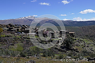 Nice black architecture town with intense blue sky and beautiful mountains in the background, Guadalajara province, Spain Stock Photo