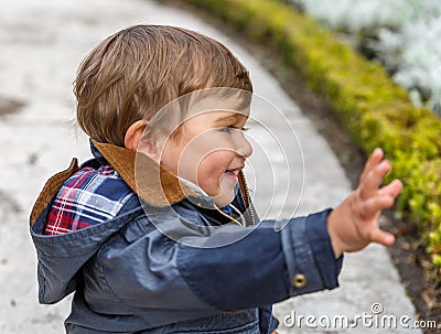 A nice child greets with his right hand Stock Photo