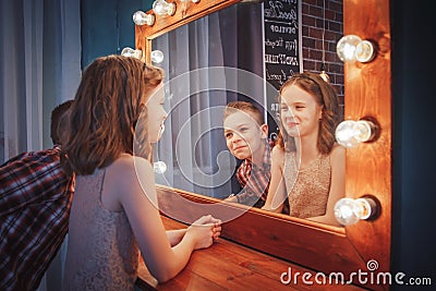 Nice children boy and girl near mirror Stock Photo