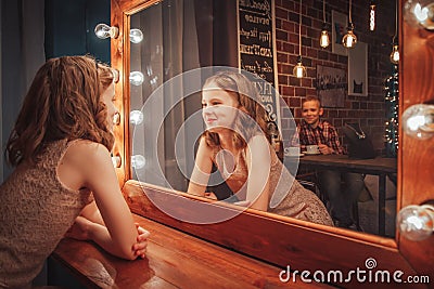 Nice children boy and girl near mirror Stock Photo