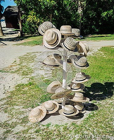 Nice closeup view of various fashionable summer straw hats on metal stand Stock Photo