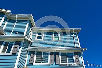 New residential townhouse on bright sunny day on blue sky background. Stock Photo