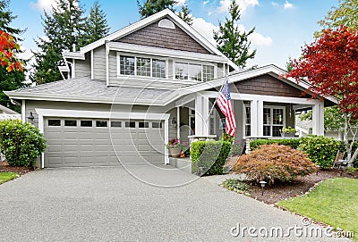Nice curb appeal of grey house with covered porch and garage Stock Photo