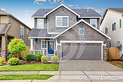 Nice curb appeal of two level house, mocha exterior paint and concrete driveway Stock Photo