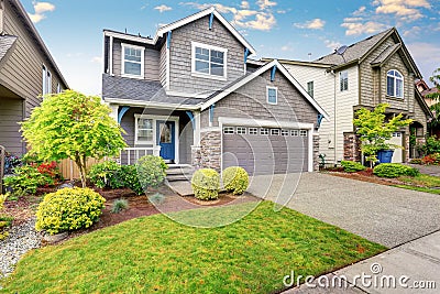 Nice curb appeal of two level house, mocha exterior paint and concrete driveway Stock Photo