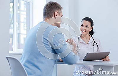 Nice doctor enjoying appointment in the hospital Stock Photo