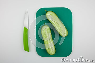 A nice fresh cut cucumber on a chopping Stock Photo