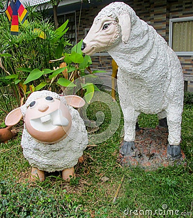 Nice funny animal figures of sheep in asian garden Stock Photo