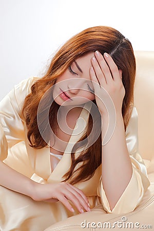 Nice girl in beige home dressing gown Stock Photo