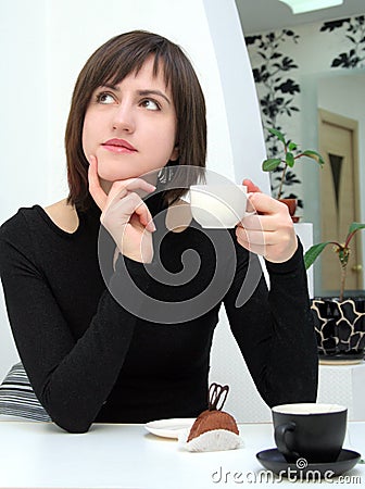Nice girl drinking coffee in a cafe Stock Photo