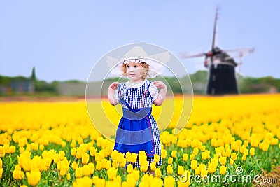 Nice Girl In Dutch Costume In Tulips Field With Windmill Stock Photo ...