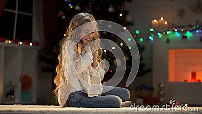 Nice girl hugging envelope, dreaming about Christmas presents, belief in miracle Stock Photo
