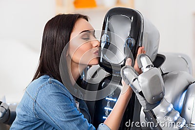 Nice girl kissing robot Stock Photo
