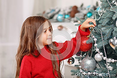 Nice girl playing near Christmas tree Stock Photo