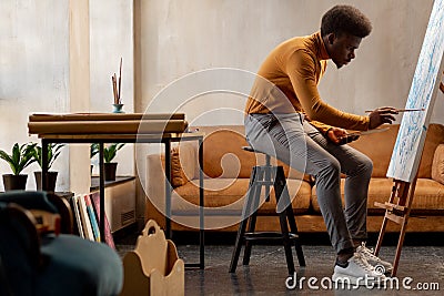 Nice hard working artist concentrating on his painting Stock Photo