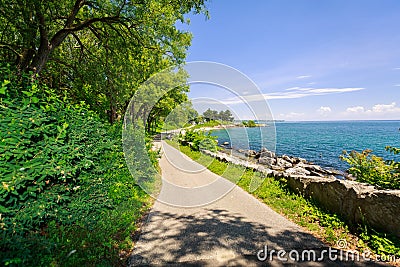 Nice inviting view of outdoor park near the lake shore on sunny summer day Stock Photo