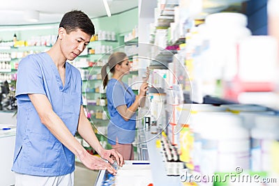 Nice japan man is searching medicines on shelves Stock Photo