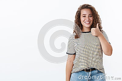 Nice job, proud you. Happy satisfied curly-haired lively plump woman show thumb up positive reply agree gesture Stock Photo