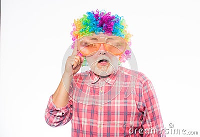 Nice joke. Elderly clown. Man senior bearded cheerful person wear colorful wig and sunglasses. Grandpa always fun Stock Photo