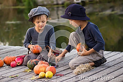 Nice kids paint small Halloween pumpkins Stock Photo