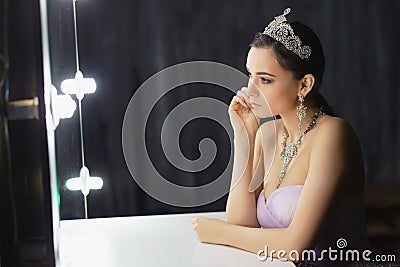 Nice lady posing in a studio near the table Stock Photo