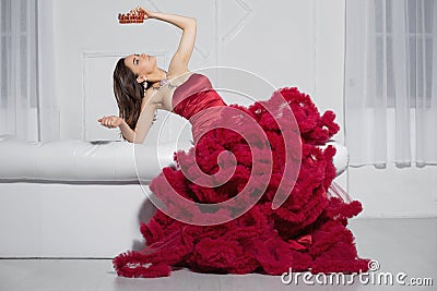 Nice lady posing in a studio posing on a sofa Stock Photo