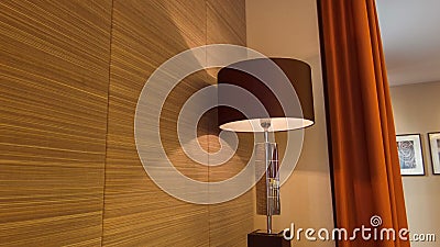 Nice lamp standign in the hotel room. More light. Dolly shot of the wall of the hotel room with tv set and lamp standing nearby Nice lamp standign in the hotel room. More light. Dolly shot of the wall of the hotel room with tv set and lamp standing nearby