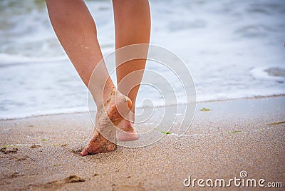 Nice legs of a pretty girl walking in water Stock Photo