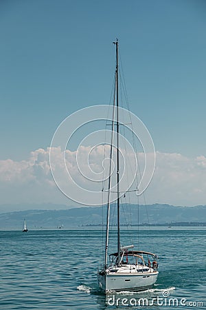 Nice little sailboat on a lake near the coast Stock Photo