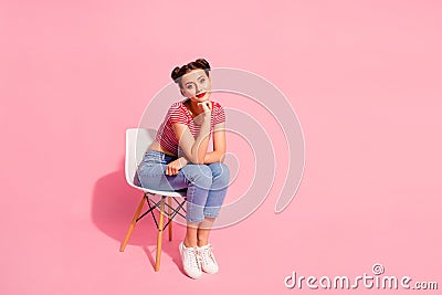 Nice-looking attractive lovely glamorous adorable winsome lovely shine teen girl wearing striped tshirt jeans sitting on Stock Photo