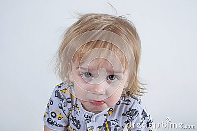 Nice offended kid with insulted expression face, purses his lips in discontent concept of children`s emotions Stock Photo