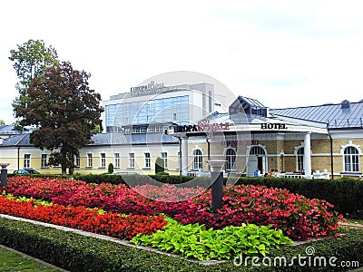 Beautiful old yellow hotel and flowers, Lithuania Editorial Stock Photo