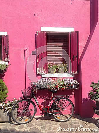 Pretty bike near the pink house on Burano island Stock Photo