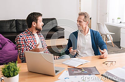 Nice pleasant men looking at each other Stock Photo