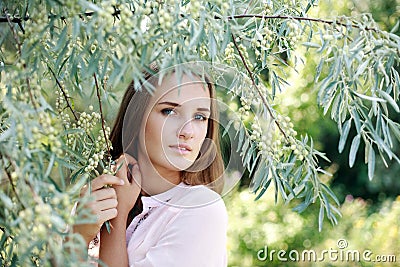 Nice portrait charming young woman under the tree Stock Photo