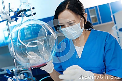 Nice positive chemist conducting a scientific experiment Stock Photo