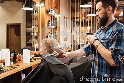 Nice professional barber spraying water at his hand Stock Photo