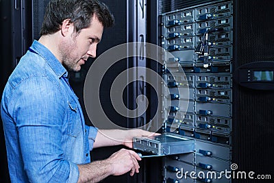 Nice professional technician installing the blade server Stock Photo