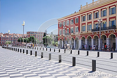 Nice, Provance, Alpes, Cote d`Azur, French, August 15, 2018; A view of the place Massena square with tramway rails, red houses. Editorial Stock Photo