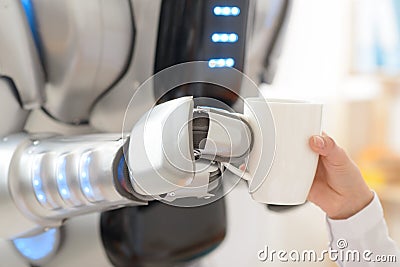 Nice robot giving cup of coffee to a girl Stock Photo
