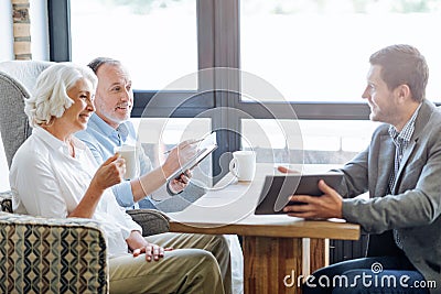 NIce smiling aged couple having meeting in the cafe Stock Photo