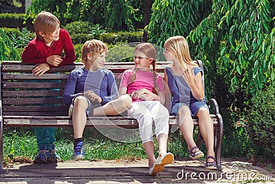 Nice smiling children sitting on the bench Stock Photo