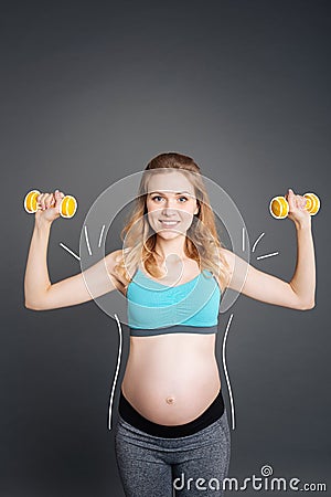 Nice smiling pregnant woman doing sport exercises Stock Photo