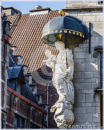 Nice statue at the corner of the facade of some building in Antwerp, Belgium Stock Photo